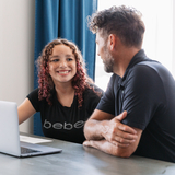 An adoptive dad sits at a table with his teen daughter
